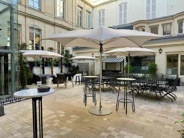 Le Lavoir outdoor courtyard with cocktail seating for luxury networking and corporate events.