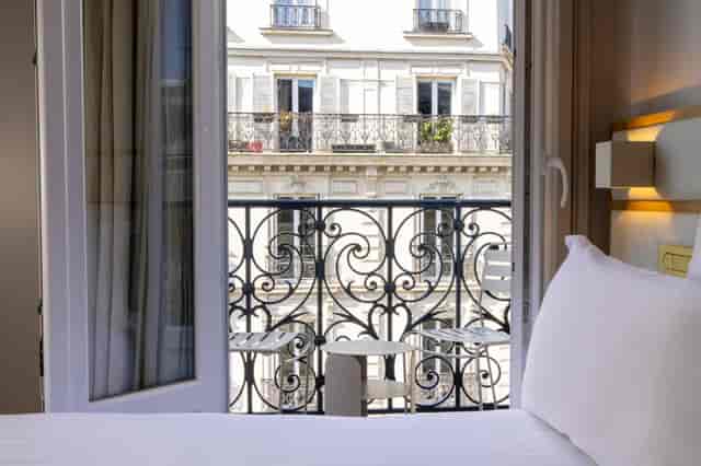 Luxury hotel room with Parisian balcony for corporate incentive travel and VIP executive events.
