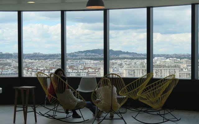 Modern restaurant breakout space with city views for corporate networking and business events.