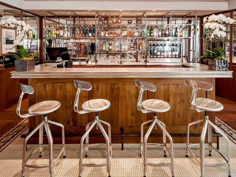 Elegant bar at Hôtel Paris Bastille Boutet, industrial-chic stools for evening event reception.