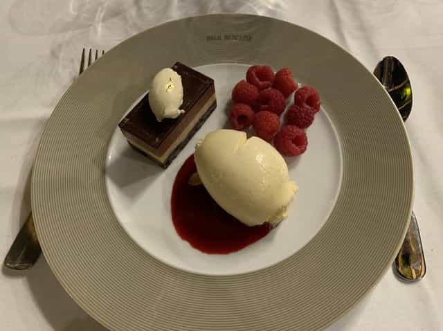 High-end plated dessert at Irma Bocuse gala dinner, gourmet catering, VIP executive event.