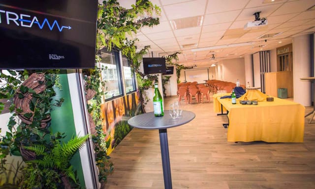 Biophilic breakout room with cabaret seating for corporate workshop or seminar.