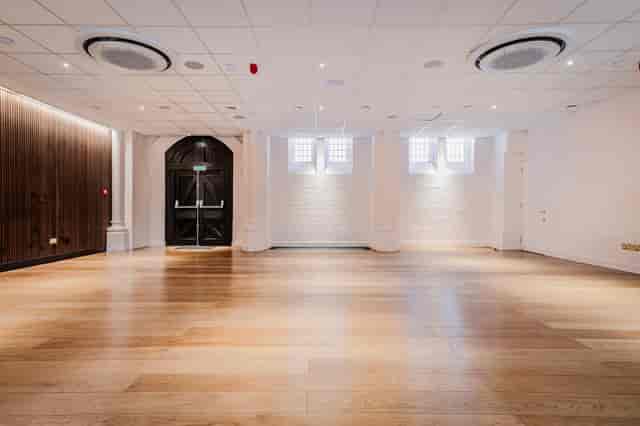 Community Hall event space with warm wood floors, ideal for modern weddings and corporate galas.