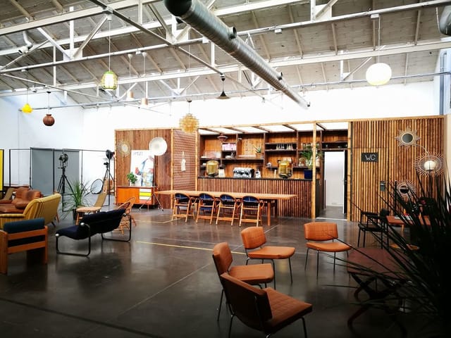 Industrial-chic event space with wood bar, perfect for creative workshops and networking events.