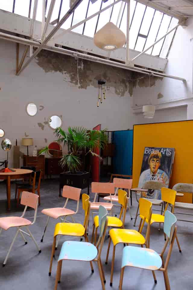 Eclectic event space at In-Sted with mismatched seating, ideal for informal workshops or galleries.
