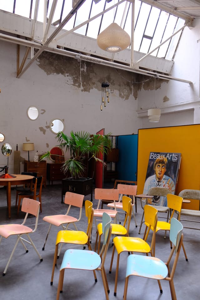 Eclectic event space at In-Sted with mismatched seating, ideal for informal workshops or galleries.