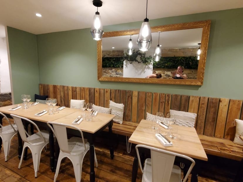 Rustic-chic Maison Moly dining room with modular tables for private events and strategy sessions.