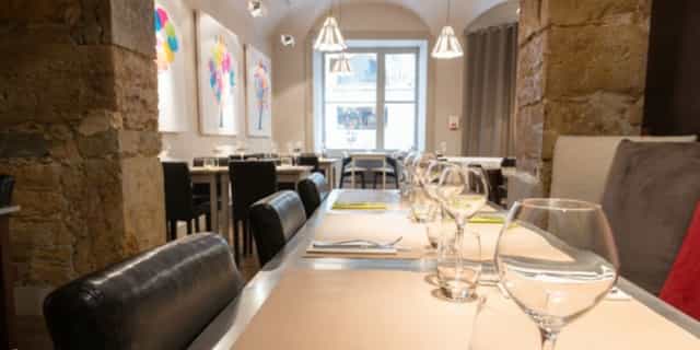 Vaulted stone restaurant for VIP board dinners and high-end breakout lunches.