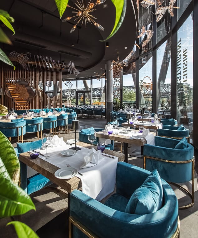 Luxury Ommia venue with teal velvet seating for corporate dinners and networking events.