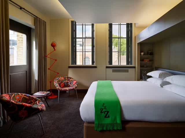 Modern hotel room at Marrable's Hotel, ideal for meetings and retreats with vibrant decor.