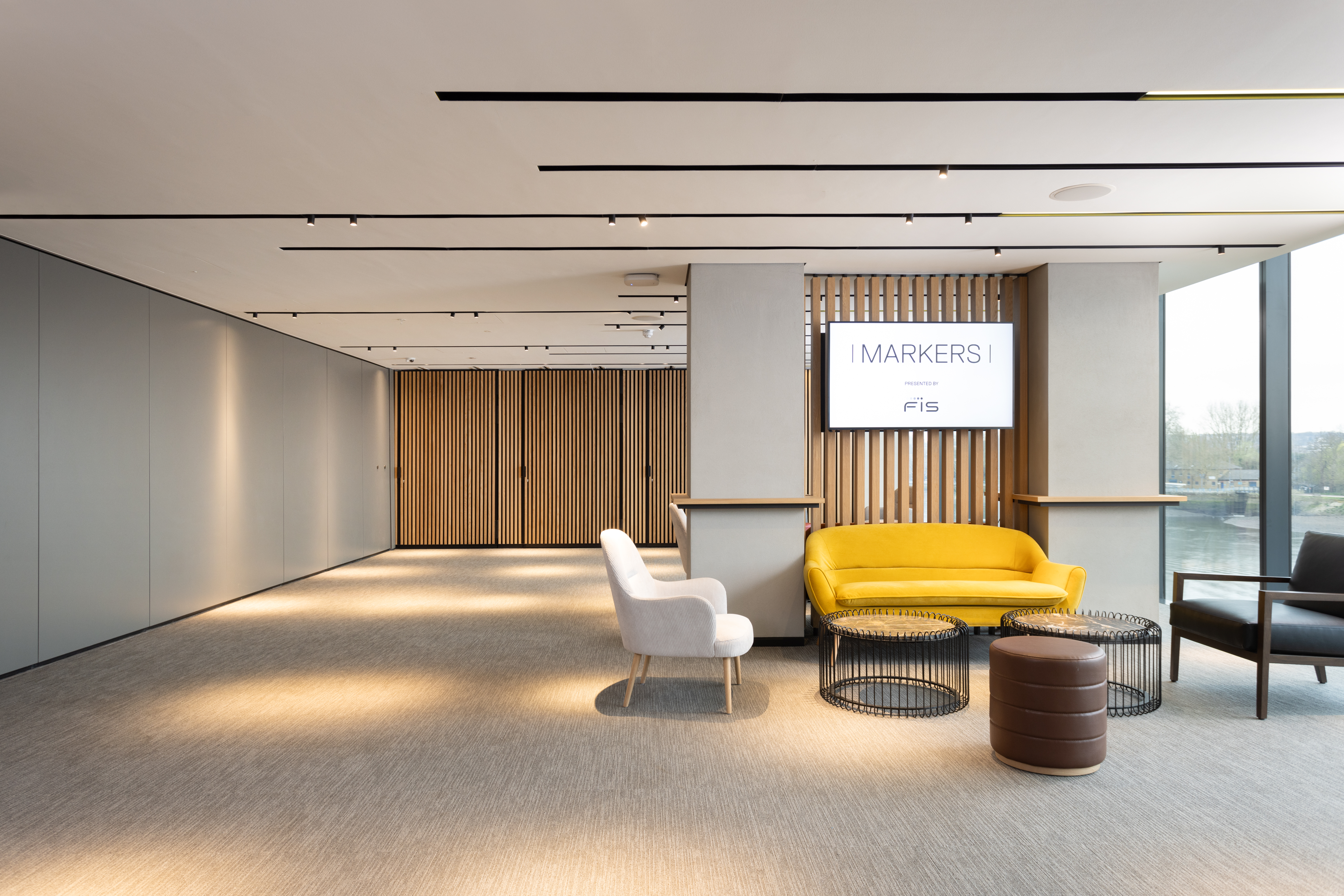 Modern meeting space at Fulham Pier with inviting yellow sofa, perfect for events.