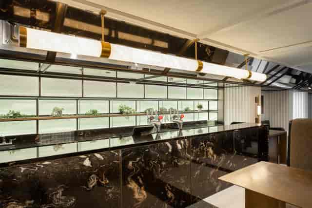 Thames Bar in Fulham Pier: modern event space with polished marble countertop, ideal for receptions.
