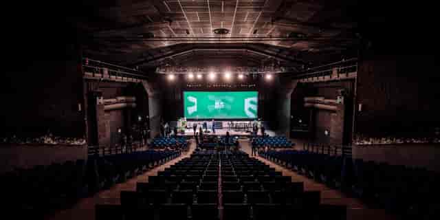 Transbordeur concert hall with stage, AV trussing, and large screen for keynote or general session.