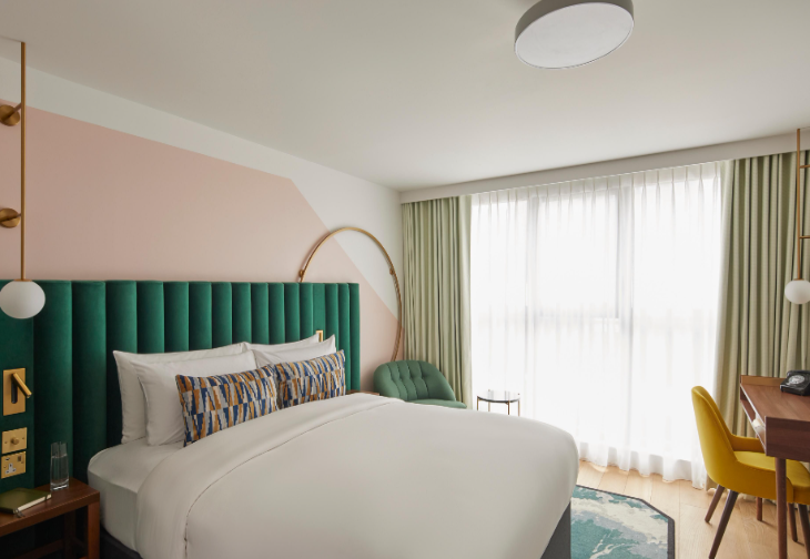 Modern Hotel Indigo London Clerkenwell guest room with workspace for business travel and retreats.