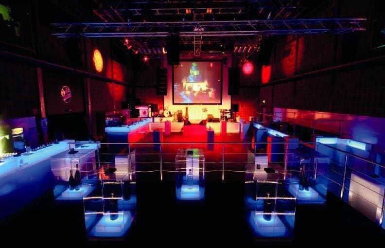 Industrial-chic Studio 2 with tiered seating, ideal for corporate events and product launches.