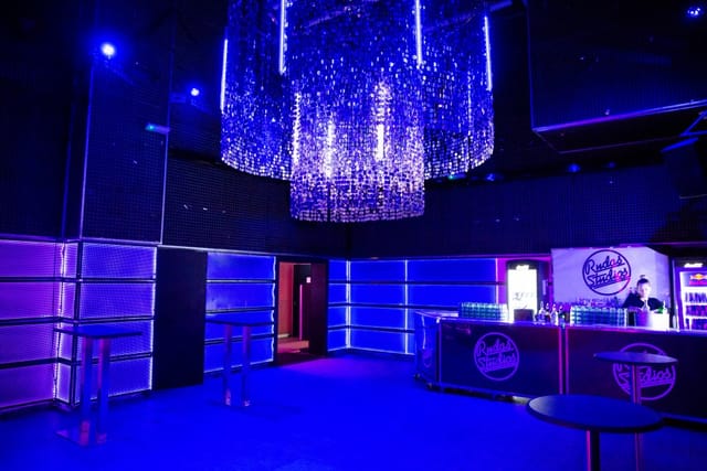 Rudas Studios lounge with LED-backlit walls for corporate events and evening receptions.