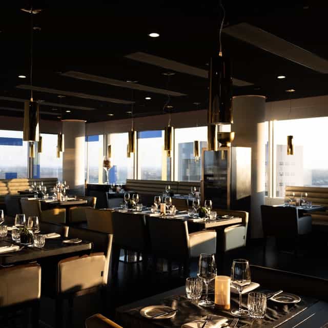 The Roof Dusseldorf: Contemporary dining venue with floor-to-ceiling windows for corporate events.