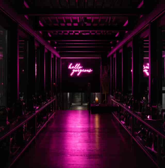 Neon-lit Ruby Coco Hotel bar entrance for gala and fashion launch events.