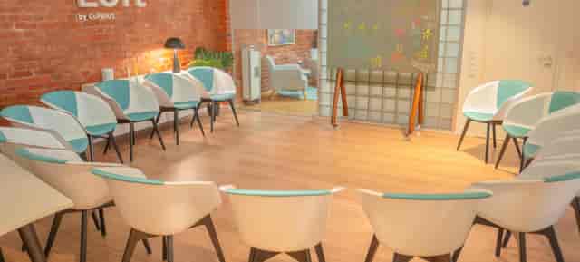 Industrial chic breakout session room with circle seating for workshops and collaborative events.