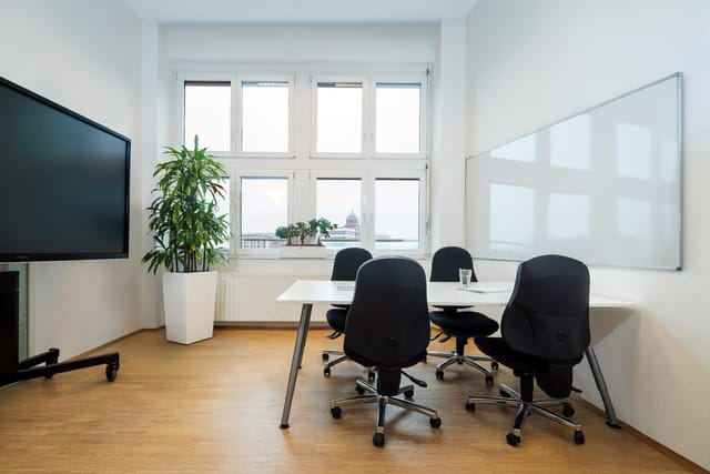 Minimalist RWI4 breakout room with AV and whiteboard for strategy sessions or team collaborations.