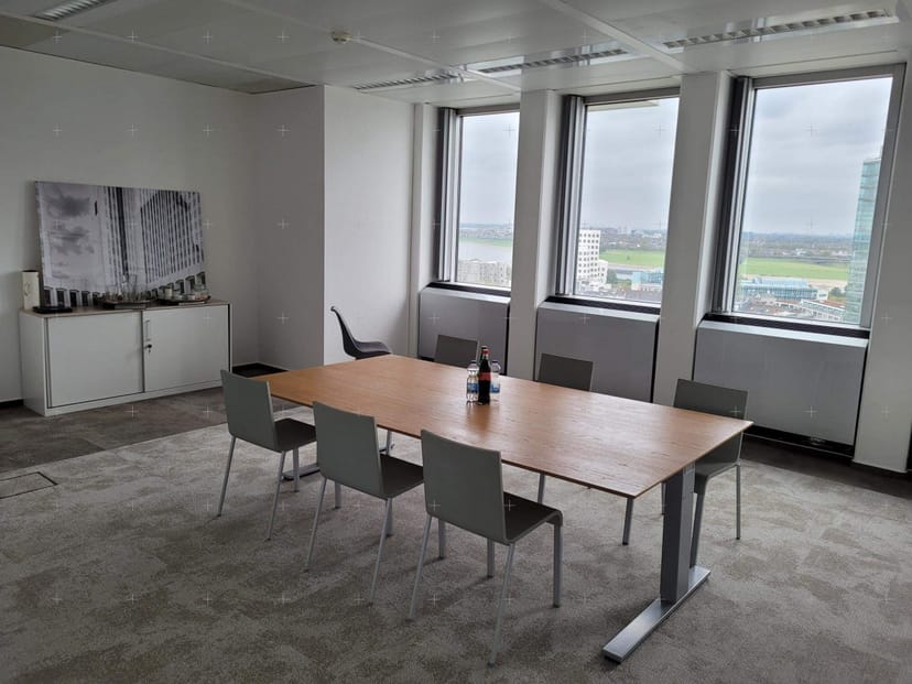 Corporate boardroom, misaligned chairs, professional meeting space, event setup.