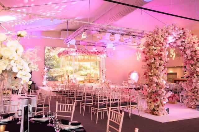 King Suite event space with immersive floral arches; perfect for luxury weddings and galas.