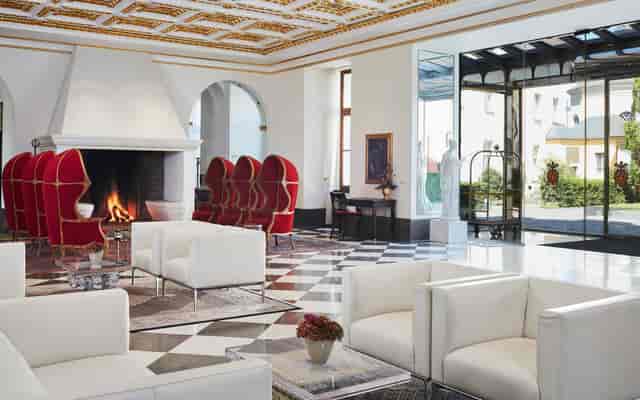 Luxury hotel lobby with red statement chairs for exclusive VIP corporate events.