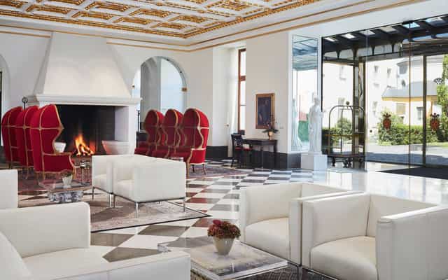 Luxury hotel lobby with red statement chairs for exclusive VIP corporate events.