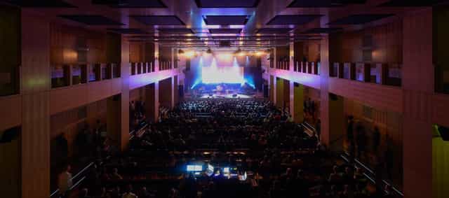 Robert-Schumann-Saal theater with stage lighting for a corporate keynote or conference event.