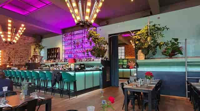 Networking reception at Areal Böhler featuring vibrant lighting and bar for premium events.