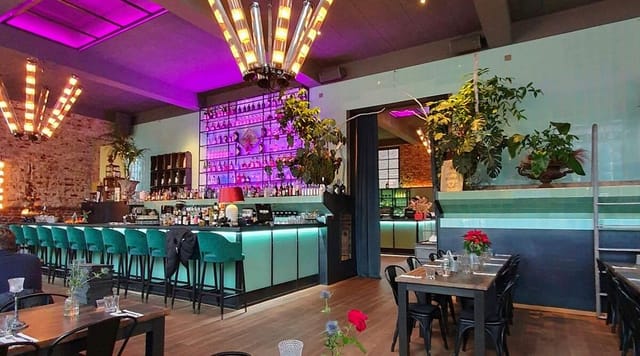 Networking reception at Areal Böhler featuring vibrant lighting and bar for premium events.