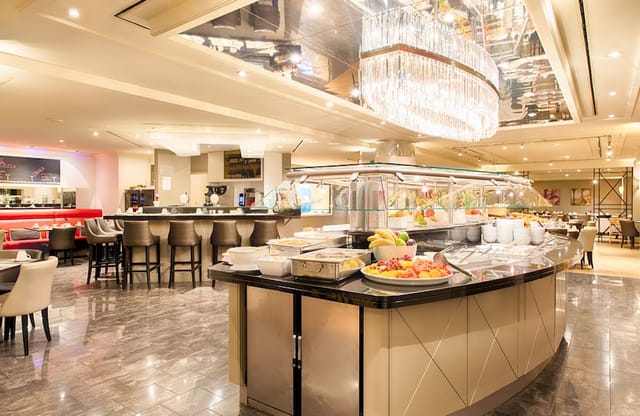 Modern hotel bar with buffet setup, ideal for corporate breakfasts and networking luncheons.