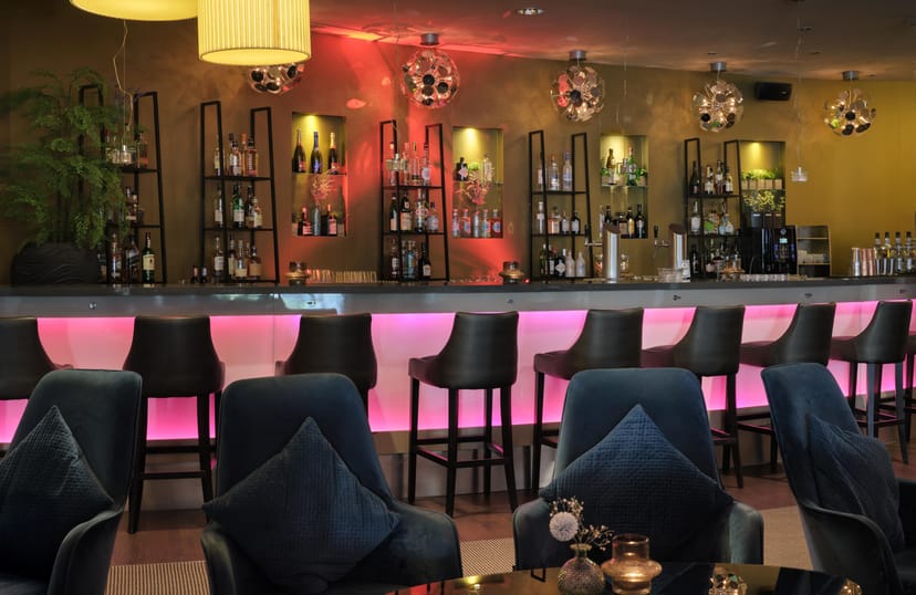 Sleek hotel bar with lounge seating, ideal for corporate networking receptions and cocktail events.