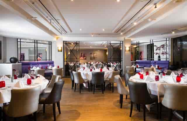 High-end banquet room with circular tables for corporate dinners and networking events.