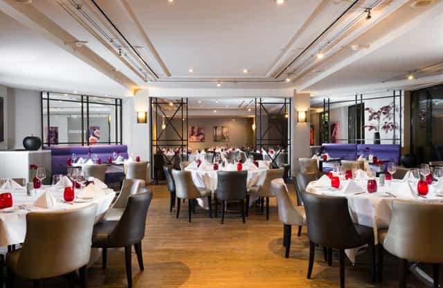 High-end banquet room with circular tables for corporate dinners and networking events.