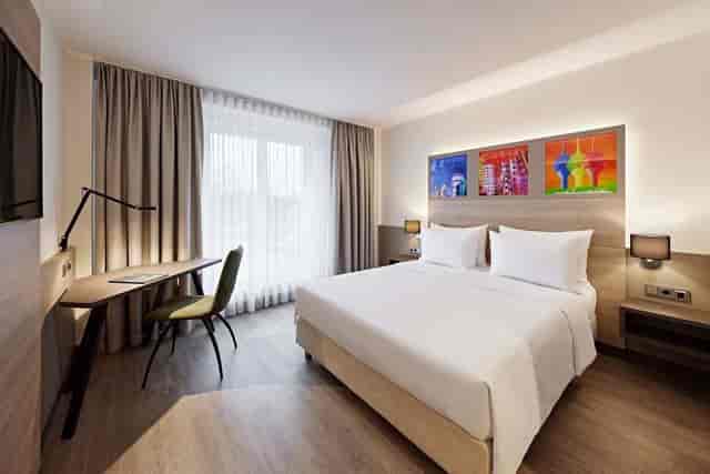 Modern hotel room with desk at Lindner Hotel Dusseldorf Airport for business travel room blocks.