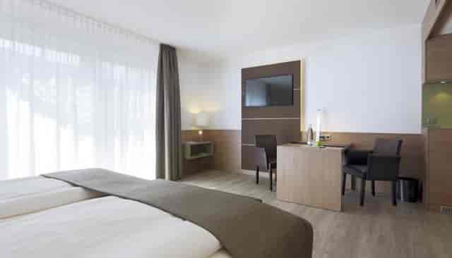 Modern hotel room in Landshut, Lindner Hotel Dusseldorf; business workspace for corporate events.
