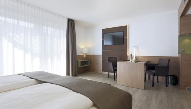 Modern hotel room in Landshut, Lindner Hotel Dusseldorf; business workspace for corporate events.