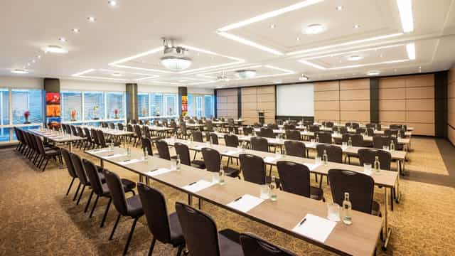 Classroom-style boardroom in Hotel Duesseldorf with natural light for corporate workshops.