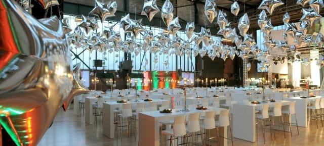 Metallic star balloon ceiling decor at Eventschmiede Düsseldorf industrial event venue.