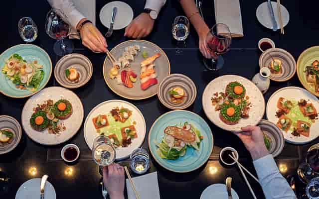 Chef's Table networking dinner with shared plates at DOX Restaurant & Bar for corporate events.