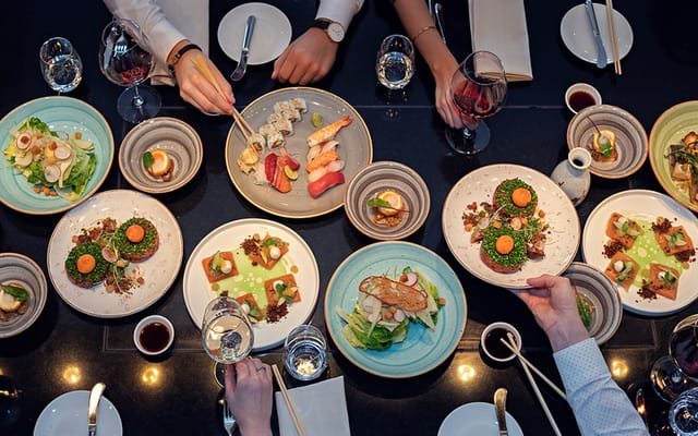 Chef's Table networking dinner with shared plates at DOX Restaurant & Bar for corporate events.