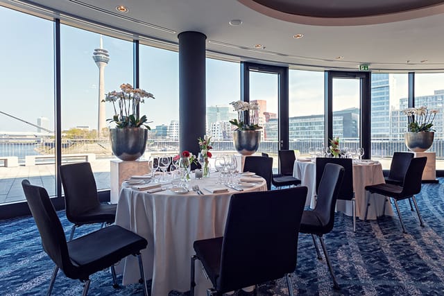 River Salon I event space at DOX with floor-to-ceiling windows for corporate dinners or networking.