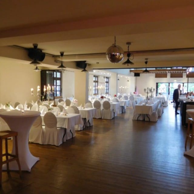 Elegant Schlossallee 1 banquet hall with formal reception tables for corporate events or weddings.