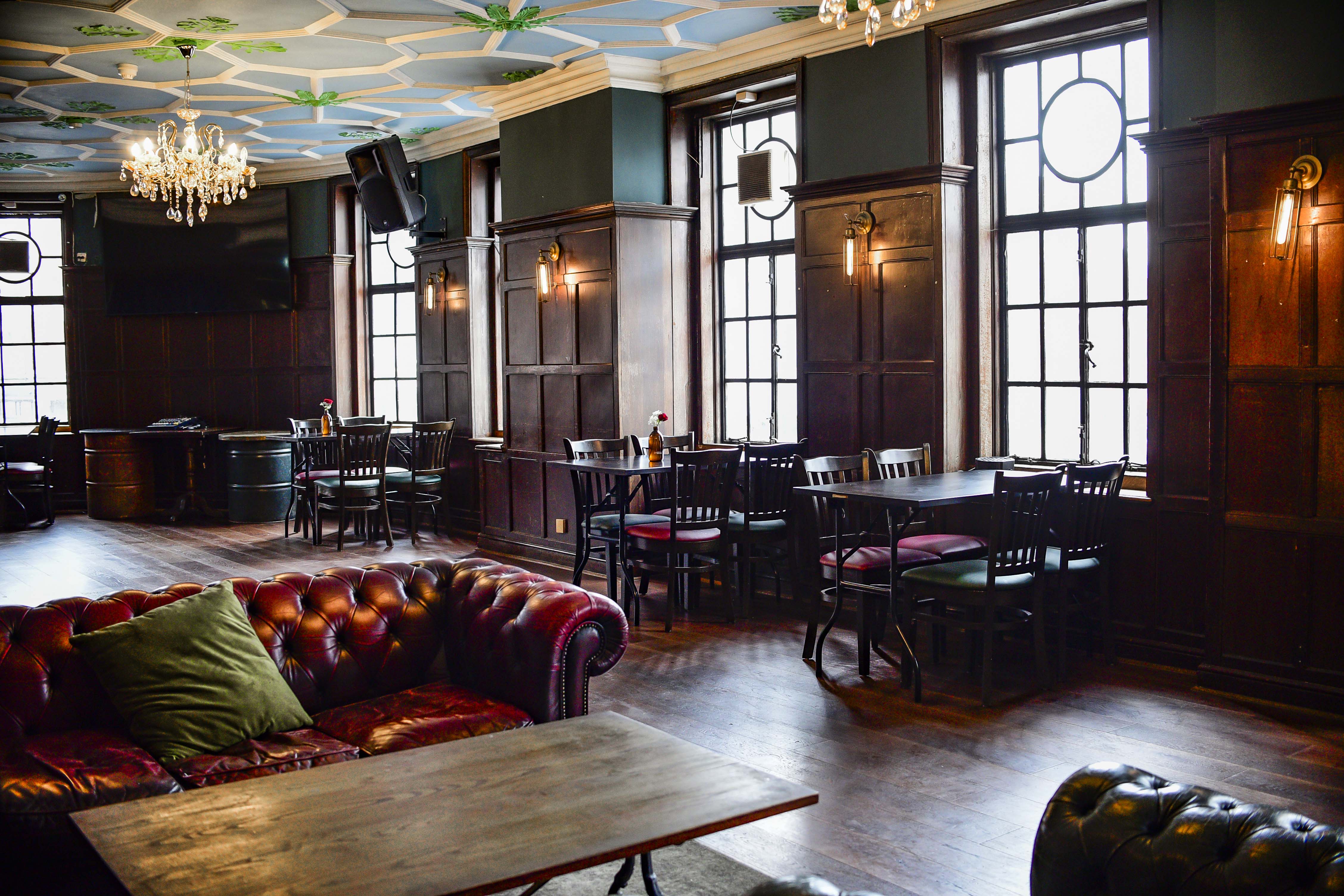 Wood-paneled function room for networking mixers and corporate events at The Ram. - Banner