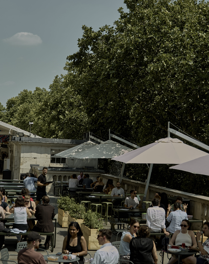 Vibrant rooftop venue for parties and private hire with inviting seating arrangements. - Banner