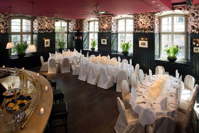 Elegant private dining setup at Wolkenburg with white linens for corporate dinner or event.