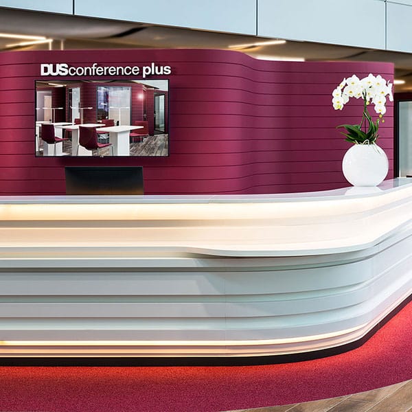Modern registration desk with digital signage for professional meeting and conference events.