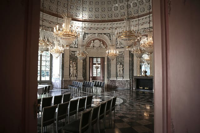 Schloss Benrath ceremonial hall with chandeliers, luxury corporate event venue, theater seating.