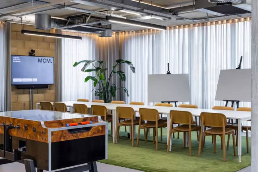 Modern conference room with long table, ideal for workshops and meetings.